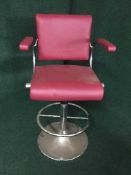 A contemporary red leather adjustable armchair on chrome base