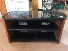 A contemporary black glass TV stand