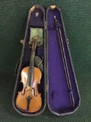 A violin and bow in coffin case bearing the label Stradivarius