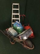 A Flymo hover compact mower, two pairs of steps, wheel barrow, tools, pick axe,