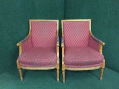 A pair of armchairs upholstered in red checked fabric