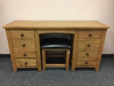 A contemporary light oak dressing table with leather topped stool