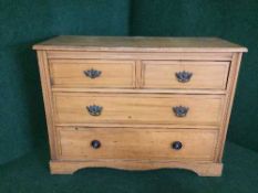 A satin walnut four drawer chest
