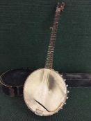 A banjo in leather carry case by Barnes and Mullins