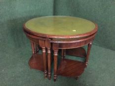 A circular glass and leather topped table fitted four beneath