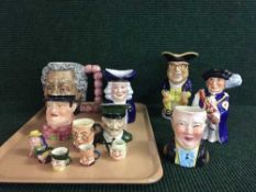 A tray of assorted toby jugs including Carlton ware Harrods jug, examples of Woods and sons,