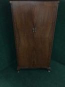 A walnut double door gentleman's wardrobe