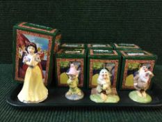 Twelve Royal Doulton Snow white and the seven dwarfs figures, some parts boxed.