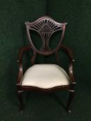 A mahogany shield back dining chair