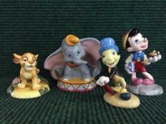 Four Royal Doulton Disney Collection figures comprising of Pinnochio, Simba, Jiminy Cricket, Dumbo.