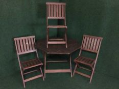 A hexagonal garden table and three chairs