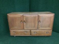 An Ercol triple door sideboard