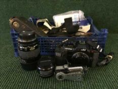 Box of Olympus OM70 camera, lenses, plate camera, Bell and Howell 8mm magazine camera etc.