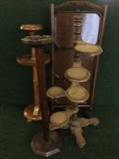 A folding oak three tier cake stand together with two smoker's stands and a whatnot