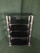 A contemporary black glass five tier audio stand