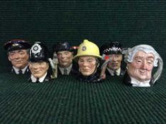 Six Royal Doulton character jugs : The Lawyer, The London Bobby, The engine Driver, The postman,