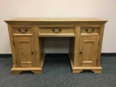 A contemporary light oak pedestal desk