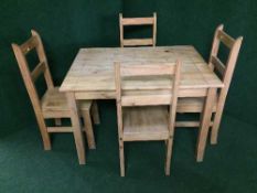 A pine kitchen table and four pine chairs