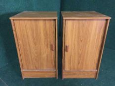 A pair of teak effect bedside cabinets