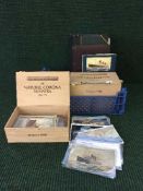 A box containing assorted postcard albums together with four cigar boxes containing a quantity of