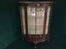 A walnut d-shaped display cabinet
