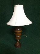 A contemporary wooden table lamp with shade