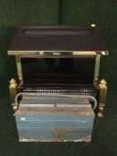 A contemporary electric fire place together with a metal tool box and tools
