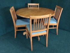 A kitchen table and four pine chairs