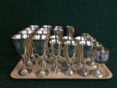 A tray of metal goblets and wine glasses