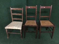 A pair of inlaid mahogany rush seated bedroom chairs and one other