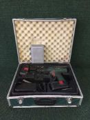 A Bosch electric sander together with a Bosch 18v electric drill with batteries in case