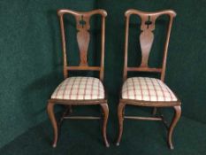 A pair of oak dining chairs