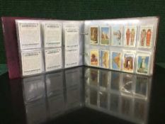 A bound folio of cigarette cards relating to various subjects : Old Furniture by Wills,