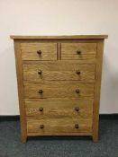 A light oak contemporary six drawer bedroom chest