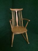 An Ercol elm rocking chair