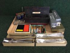 A tray of various cutlery, cocktail forks, glass inkwells etc.