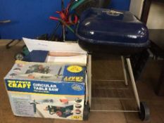 A boxed Powercraft circular table saw and a BBQ
