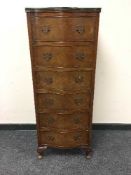 A walnut slim tall boy