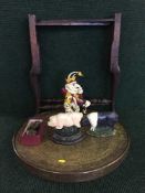 A folding oak brass topped table with three cast iron door stops and a boxed celtic art wall pocket