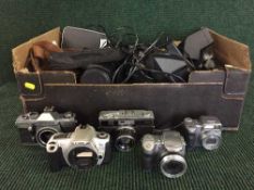 A box of cameras and electrical's together with a box of unframed art work