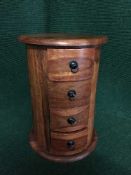 A cylindrical four drawer chest