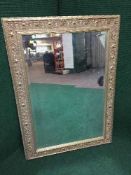 A decorative gilt framed bevelled overmantle mirror