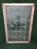 A framed leaded glass window