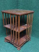 An inlaid mahogany revolving book stand