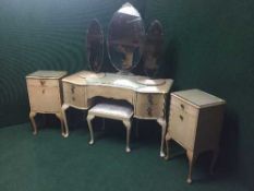 An eight piece walnut bedroom suite : two wardrobes, dressing table with stool, 4'6 headboard,