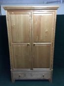 A contemporary pine double door wardrobe fitted a drawer