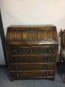 A carved oak bureau,