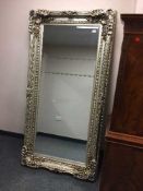 A highly ornate silvered bevelled mirror,