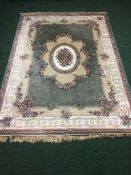 A silk finished rug on green ground