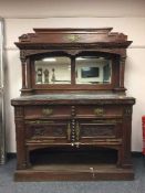 An oak mirror backed marble top sideboard,